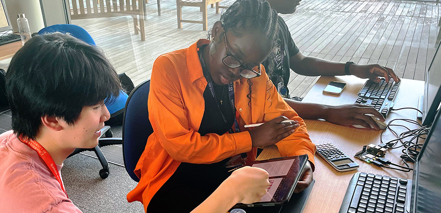A participant working with a subject ambassador at the 2023 Sutton Trust Summer School A participant working with a subject ambassador at the 2023 Sutton Trust Summer School