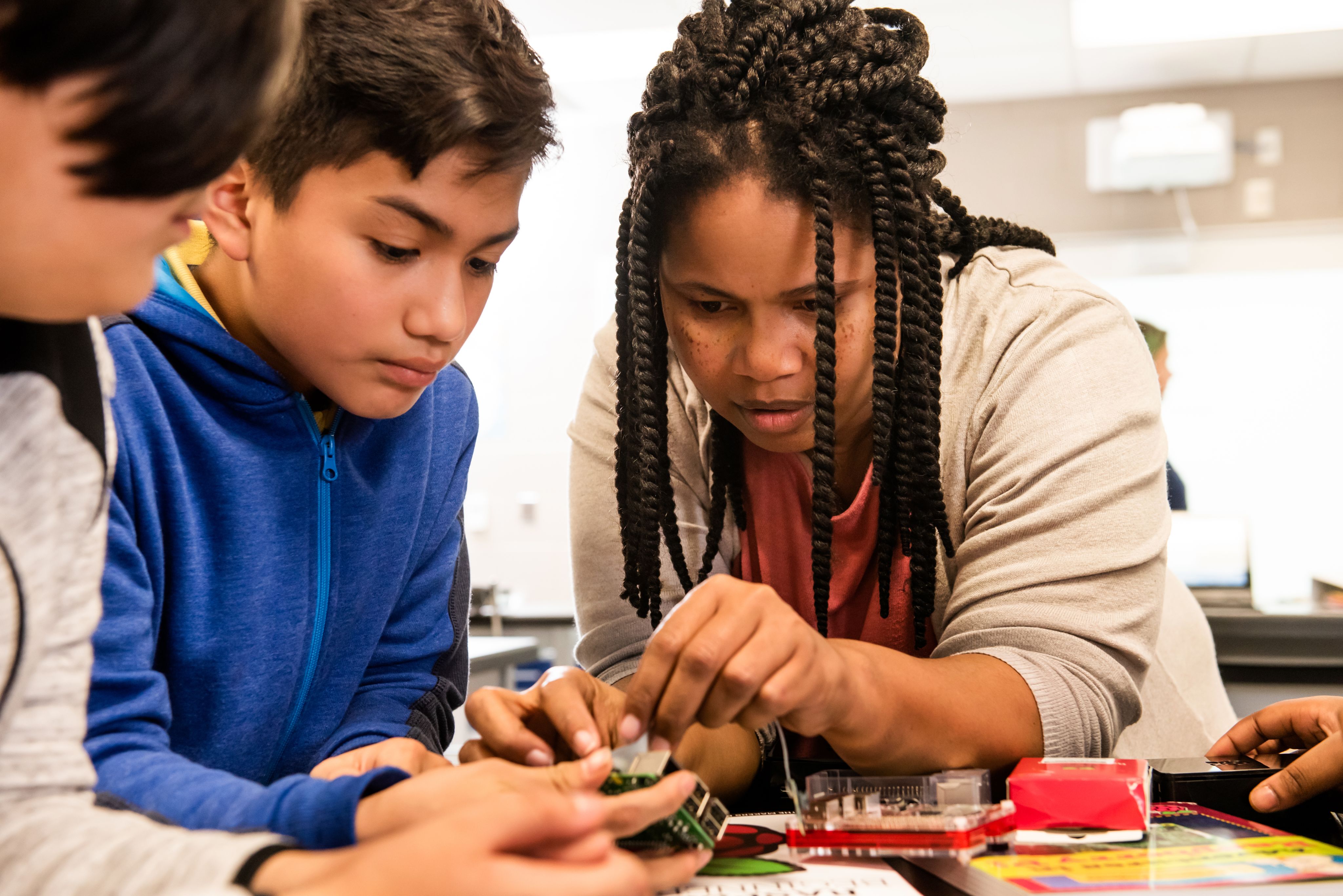 Adult and young person working with Raspberry Pi